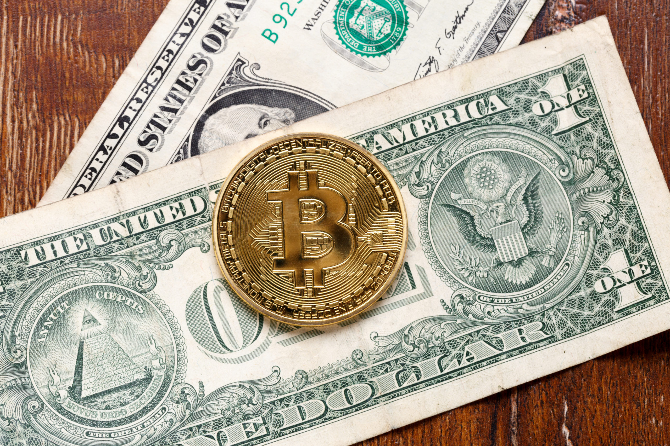 bitcoin dollar bills on table scaled 1 Crypto relief: Bitcoin jumps 10% as it bounces from 10-month low