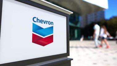 chevron sign people background 740x416 1 This activist investor is pushing Chevron to ‘boost’ oil production