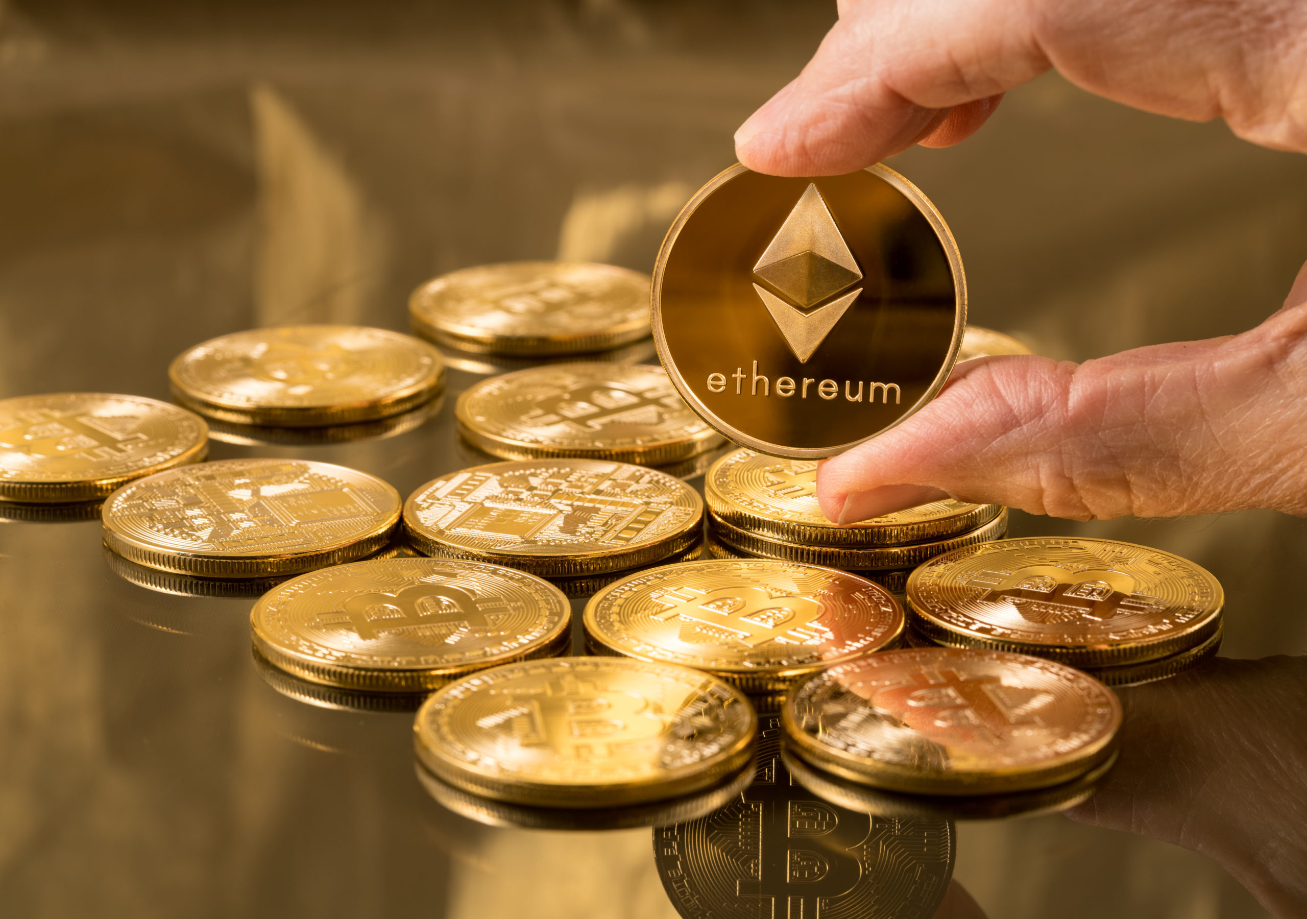 man holds ethereum coin scaled 1 SEBA Bank launches Ethereum staking for institutional investors